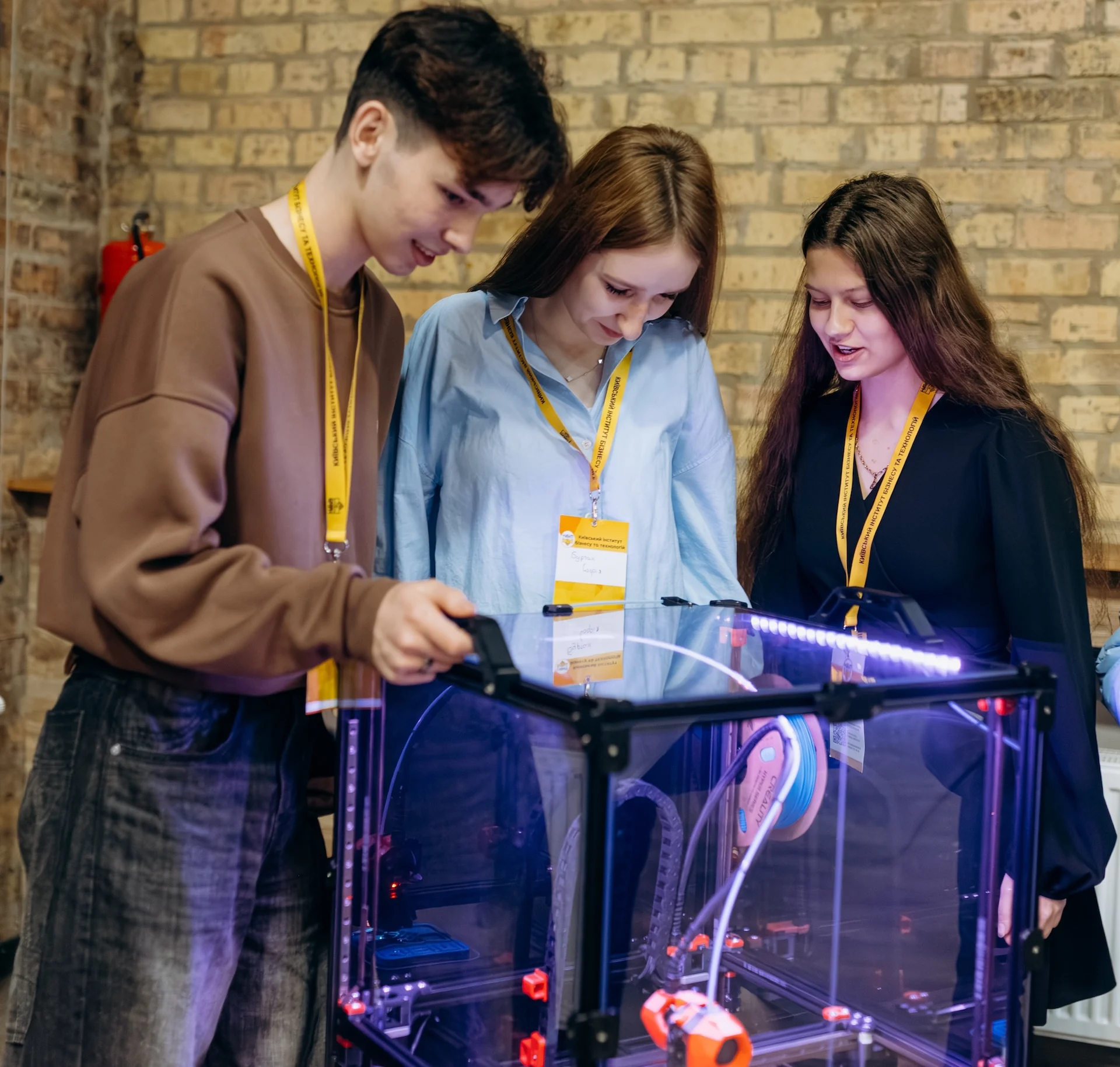 Студенти біля 3D-принтера в КІБІТ
